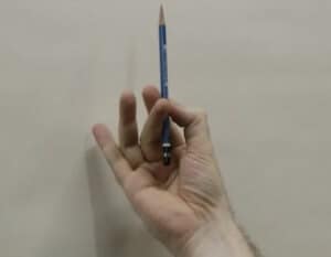 Hold the pencil between the thumb and index finger, with the middle finger helping to stabilize. The ring finger and pinkie finger float free.