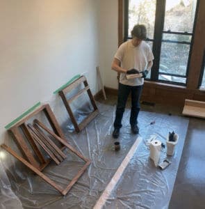 applying wood stain to the easel components